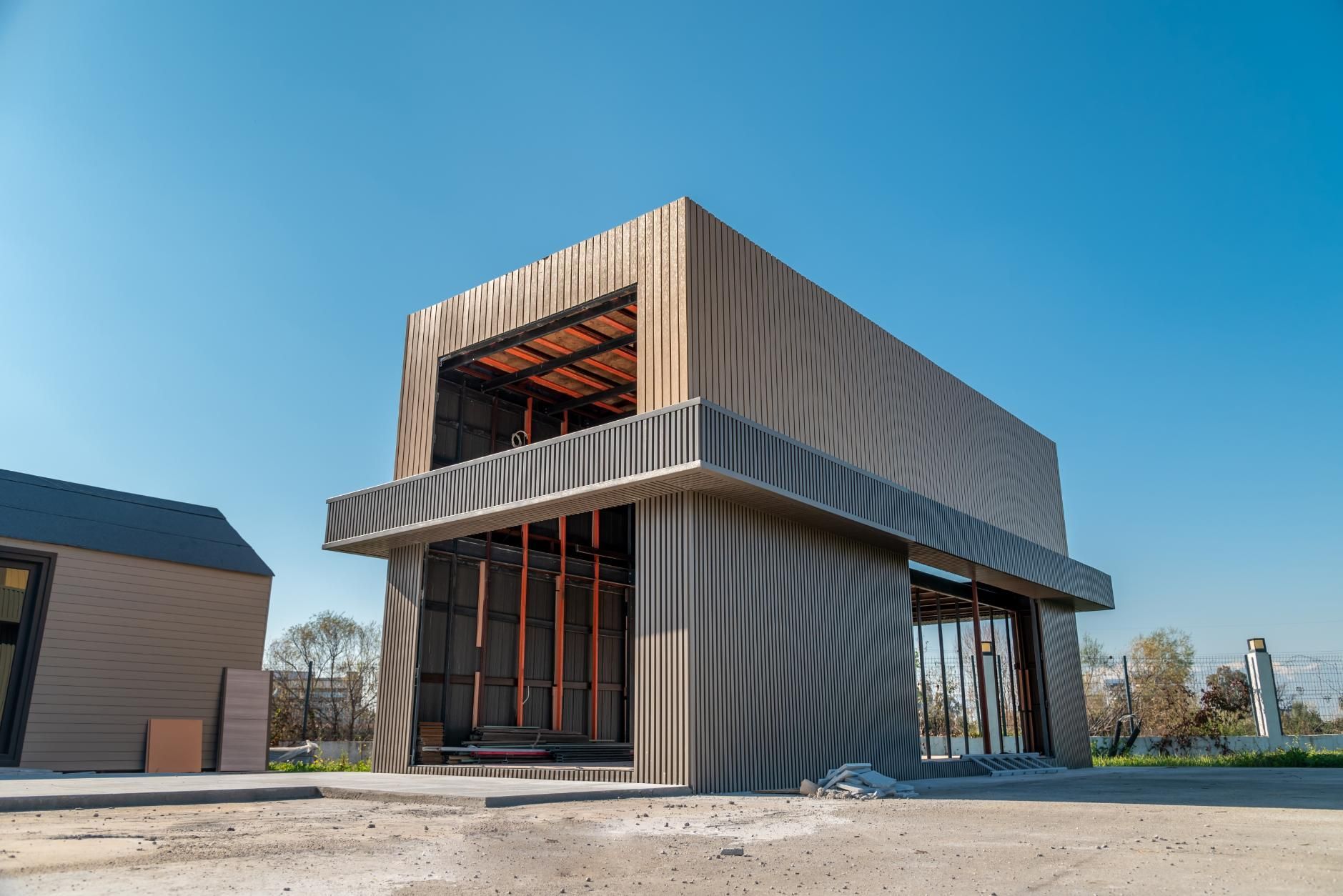 A building under construction with a zebra print on the side.