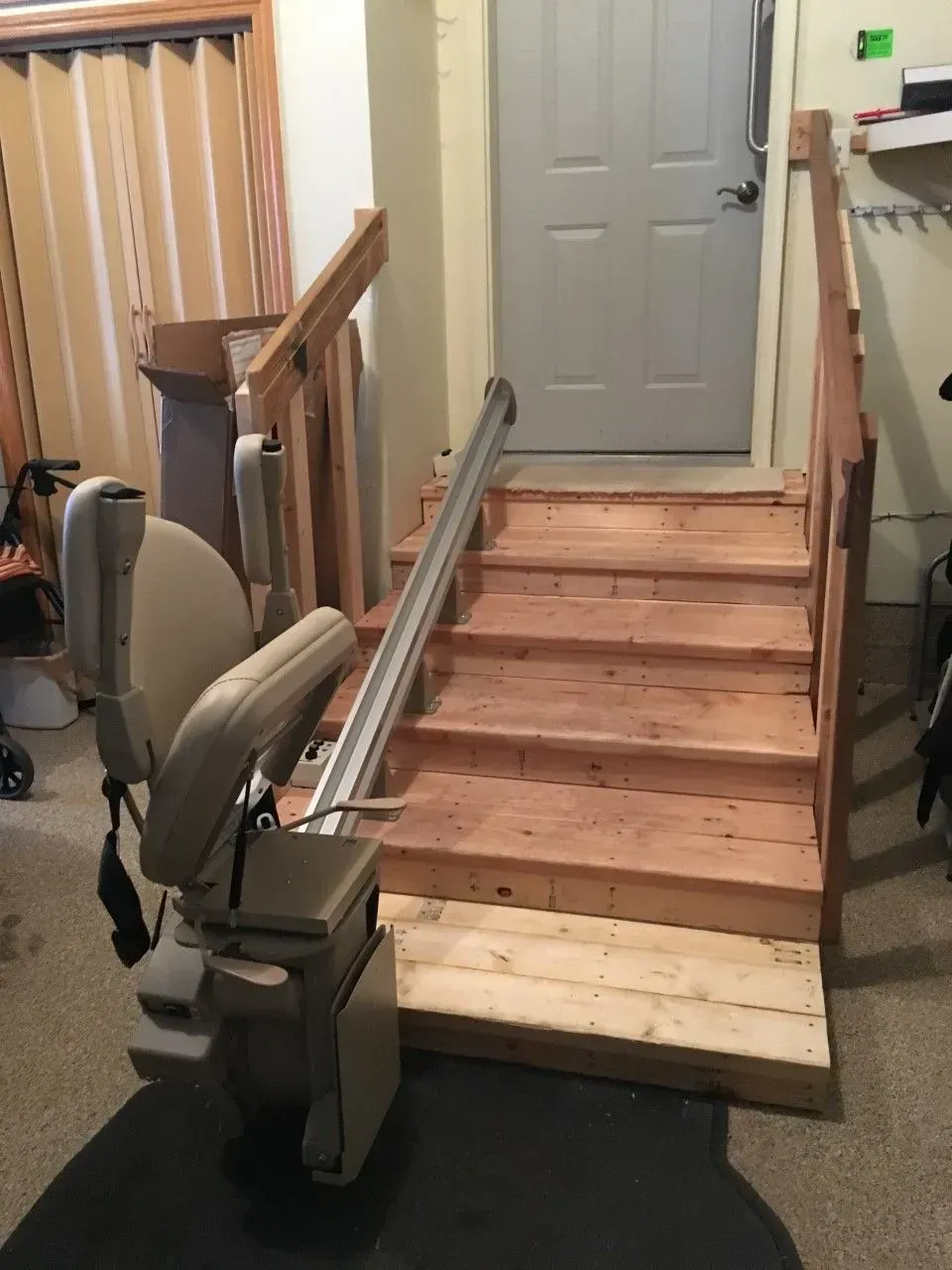 Interior stair lift installed on a wooden staircase in a home hallway