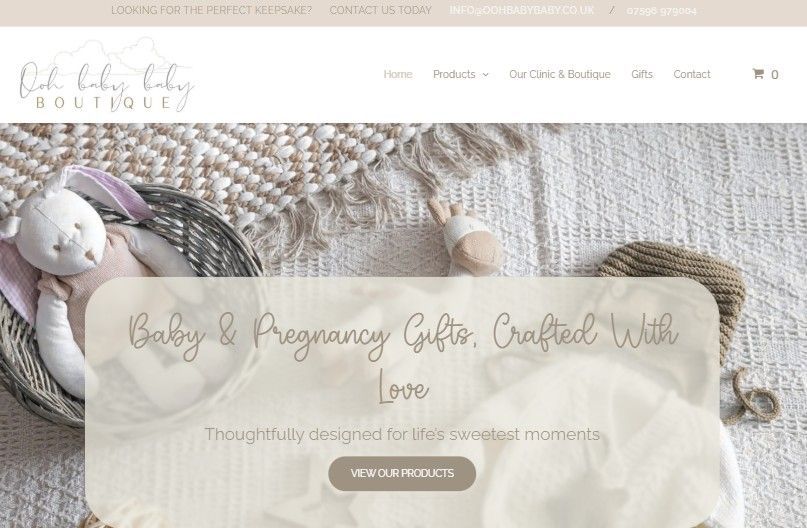 Pastel baby and pregnancy gifts displayed on a lace blanket with a “Shop our products” banner