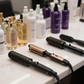 Hair styling tools and bottles of hair products arranged on a salon counter