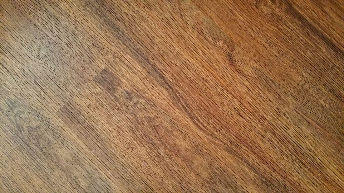 Close-up of a brown wooden surface with visible grain patterns
