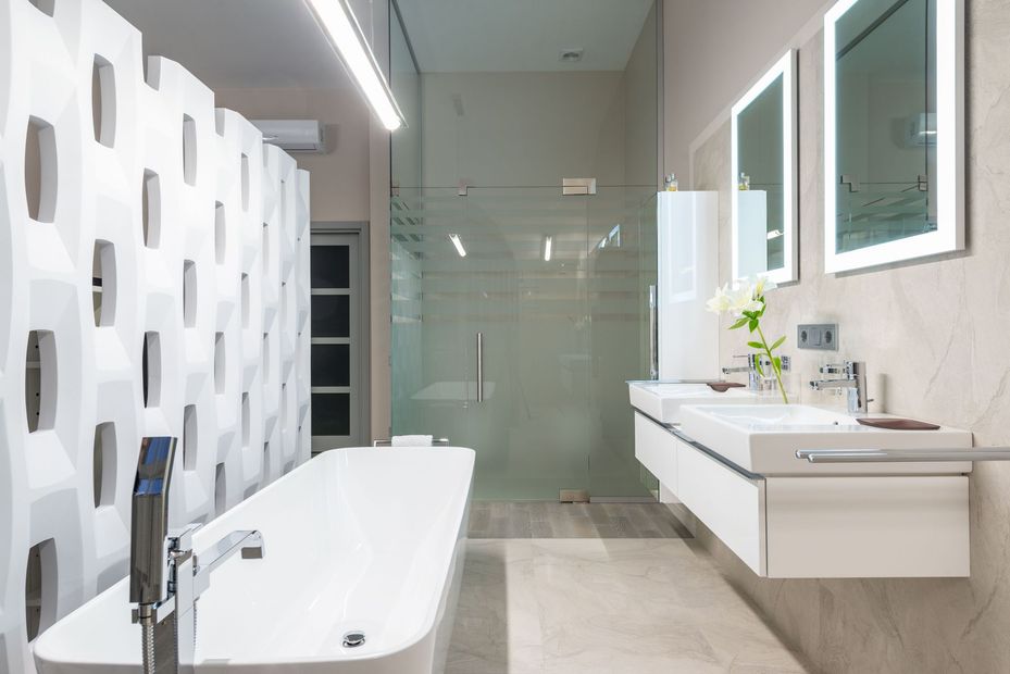 Modern bathroom with white tub, sink vanity, glass shower, and patterned wall tiles