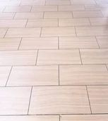 Light wood plank flooring with a subtle horizontal tile pattern