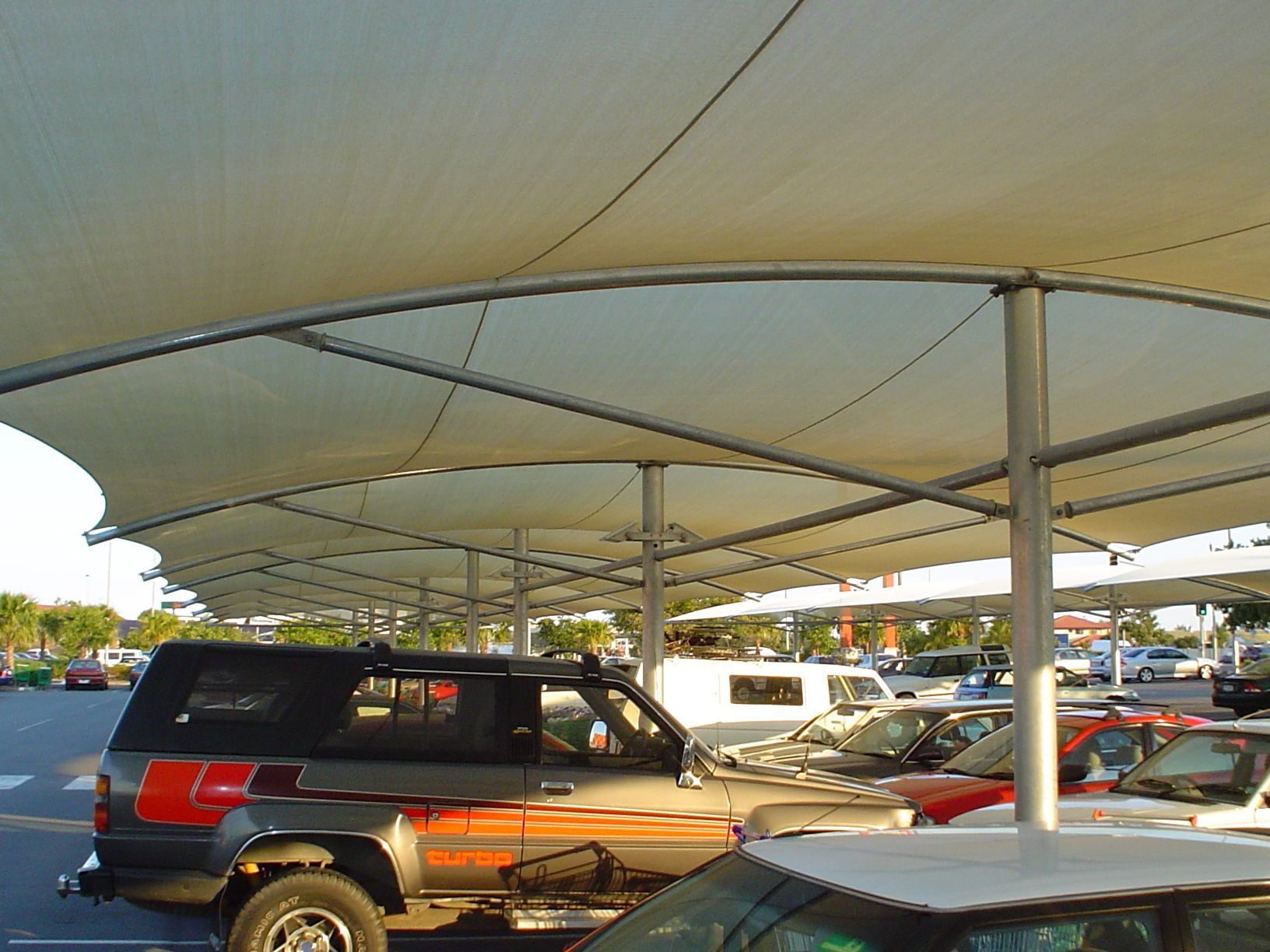 A Shaded Parking Area With a Canopy Over Rows of Parked Cars — The Gazebo and Shade Centre in Jindera, NSW