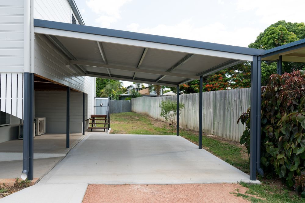 Carport Attached to a House With Gray Roof and Posts — The Gazebo and Shade Centre in Jindera, NSW