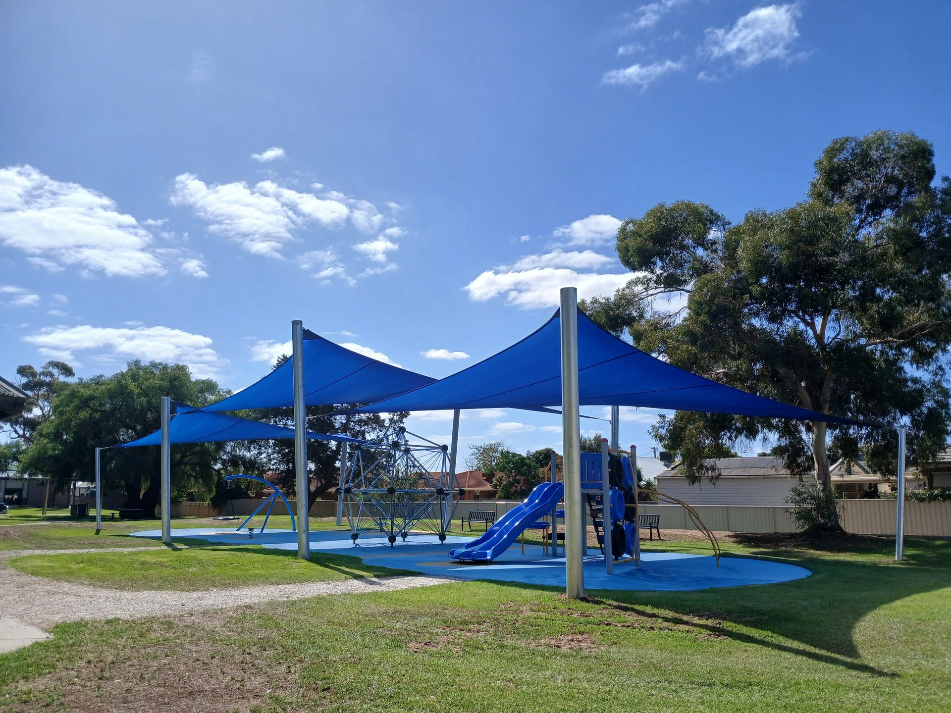Blue shade canopy over playground equipment in a park under a sunny sky  — The Gazebo and Shade Centre in Yarrawonga, VIC