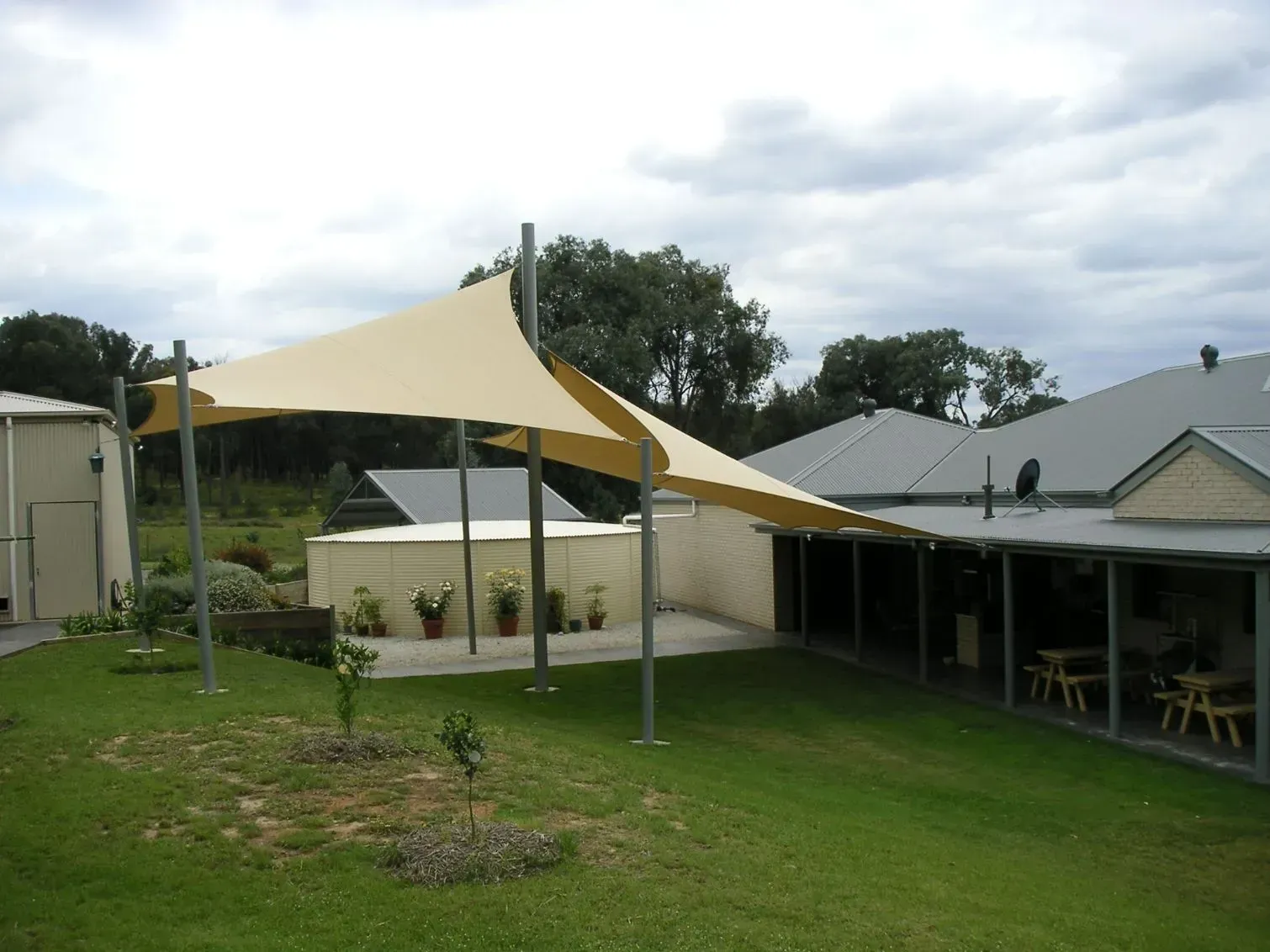 Beige Shade Sail Over a Grassy Area, Supported — The Gazebo and Shade Centre in Jindera, NSW
