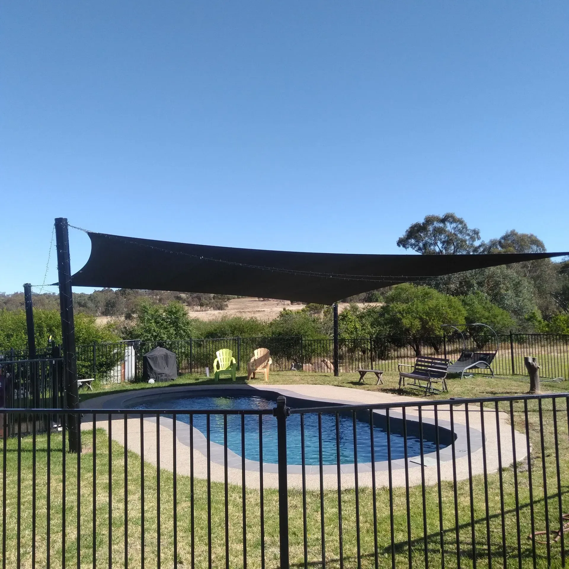 Swimming Pool With a Black Shade Sail — The Gazebo and Shade Centre in Jindera, NSW