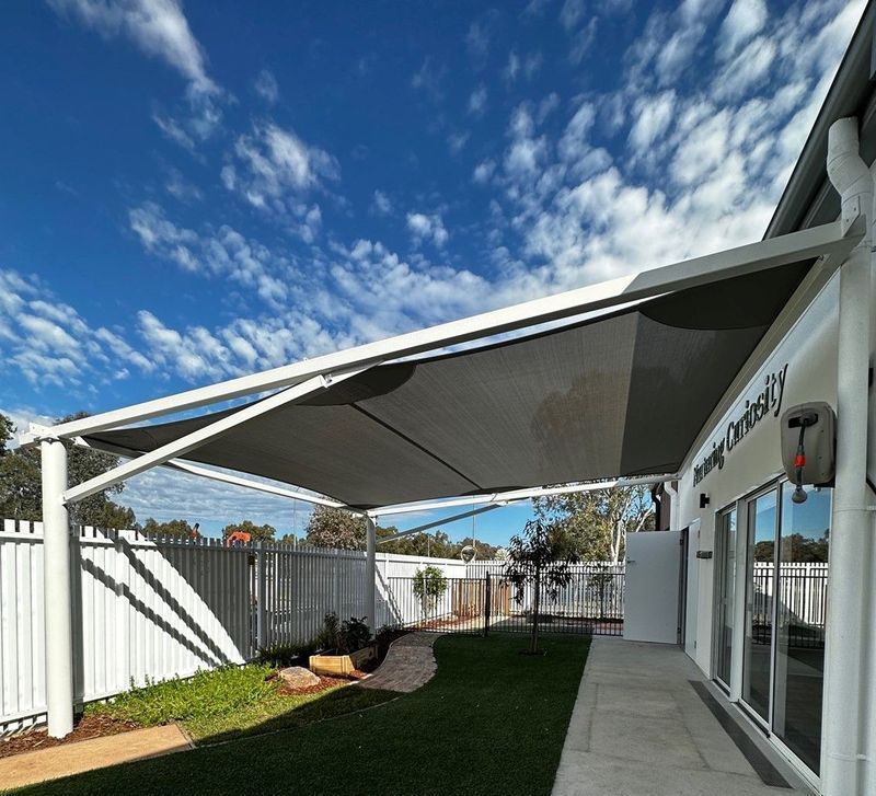 Grey Shade Sail Covers a Backyard Patio — The Gazebo and Shade Centre in Beechworth, VIC