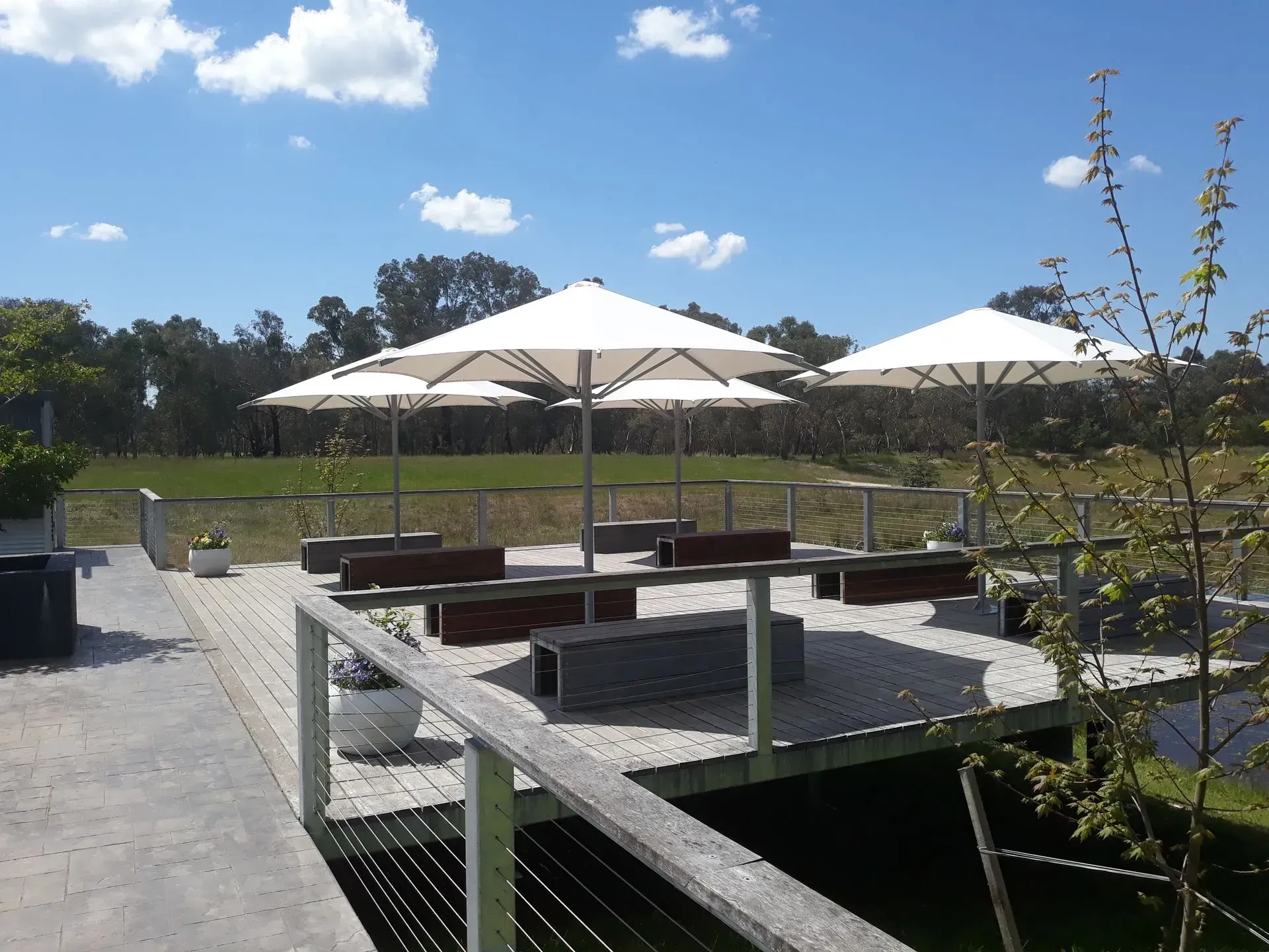 Outdoor Seating Area With White Umbrellas — The Gazebo and Shade Centre in Jindera, NSW