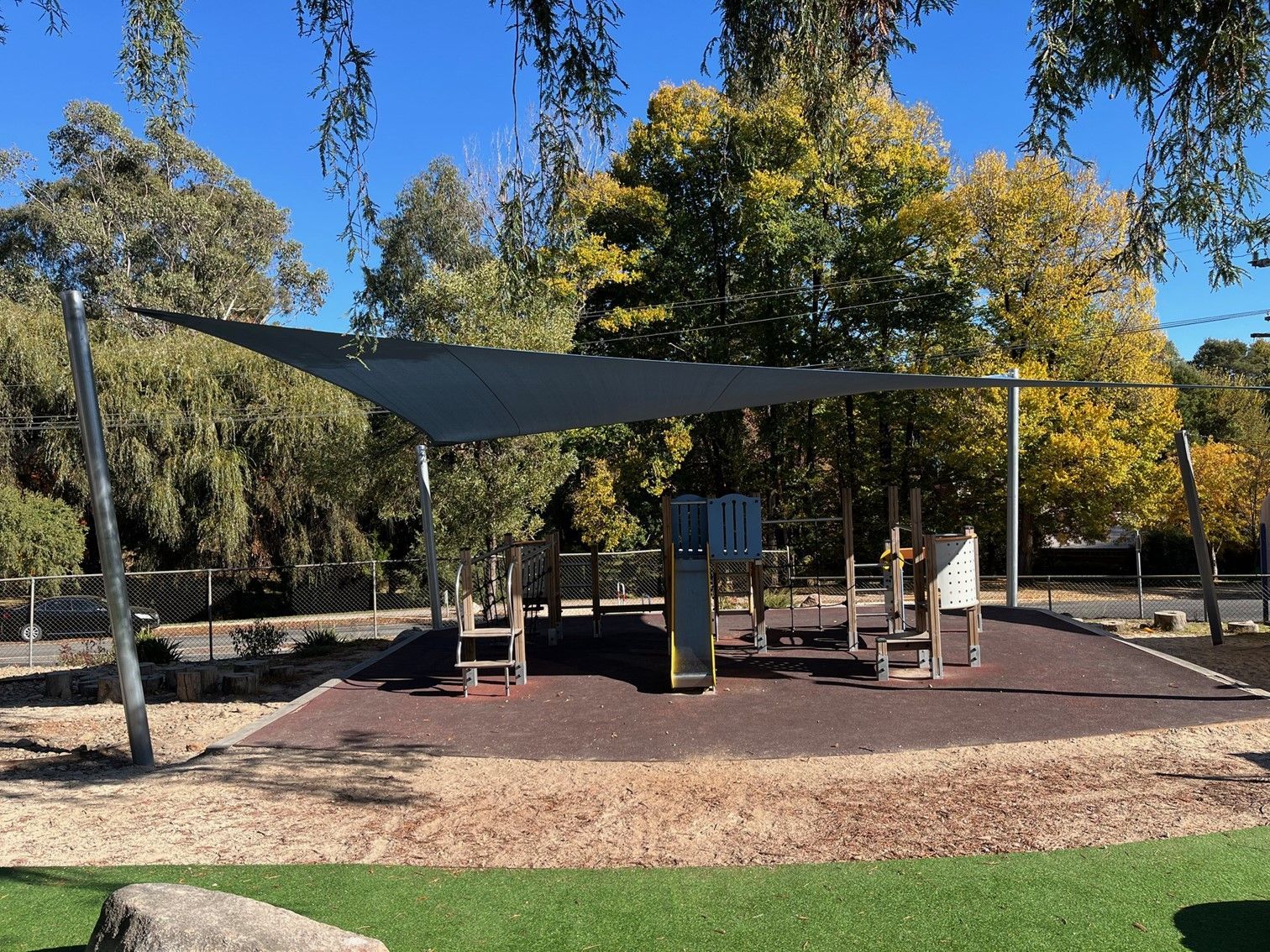 Shaded playground with climbing structures and benches in a park under trees — The Gazebo and Shade Centre in Beechworth, VIC