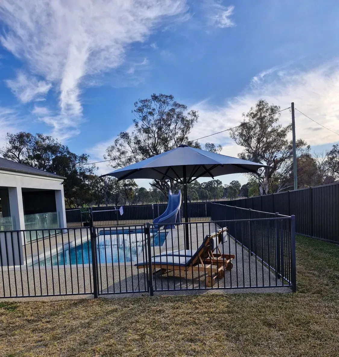 Pool Area With Black Fence — The Gazebo and Shade Centre in Jindera, NSW