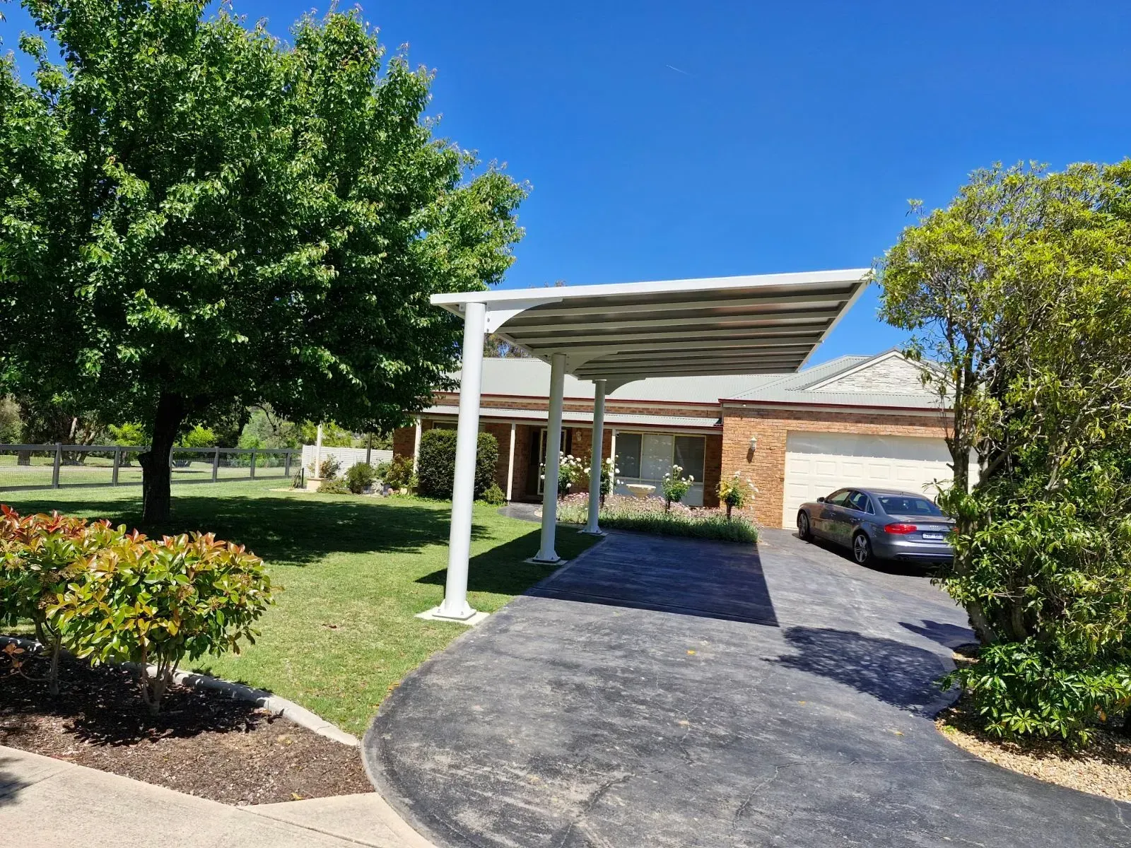 Carport Covering a Driveway Leading to a Brick House — The Gazebo and Shade Centre in Jindera, NSW