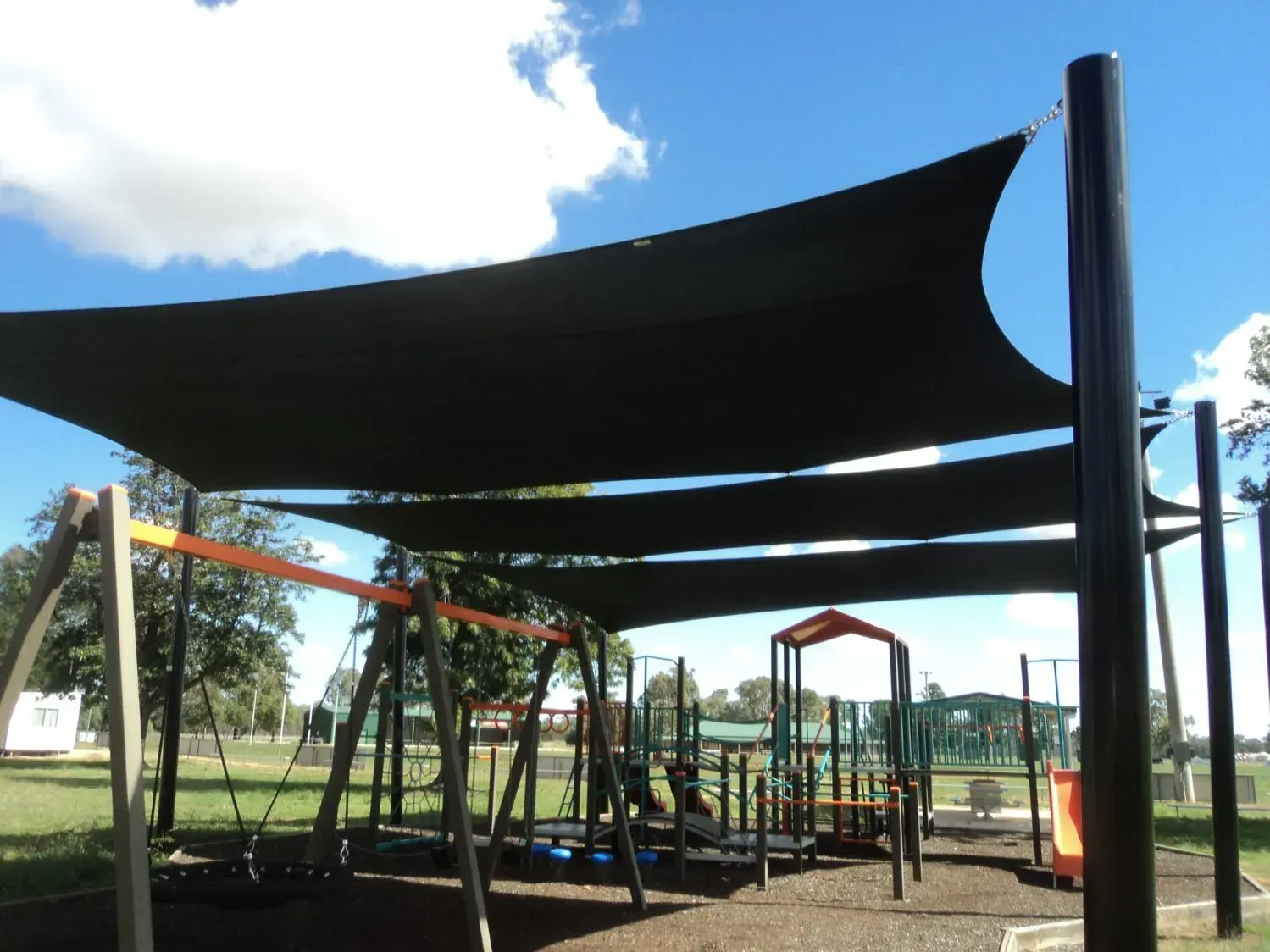A Black Shade Sail Structure Covers a Playground — The Gazebo and Shade Centre in Jindera, NSW