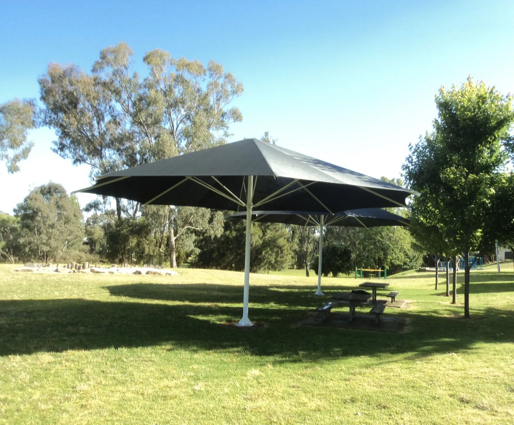 Picnic Area With Two Large Black Umbrellas — The Gazebo and Shade Centre in Jindera, NSW