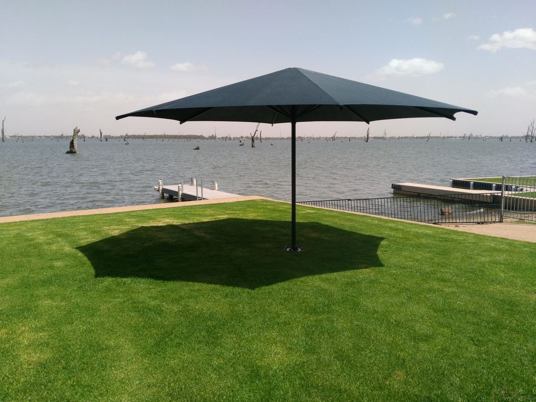 A Dark Square Patio Umbrella Stands on a Grassy Lawn — The Gazebo and Shade Centre in Jindera, NSW