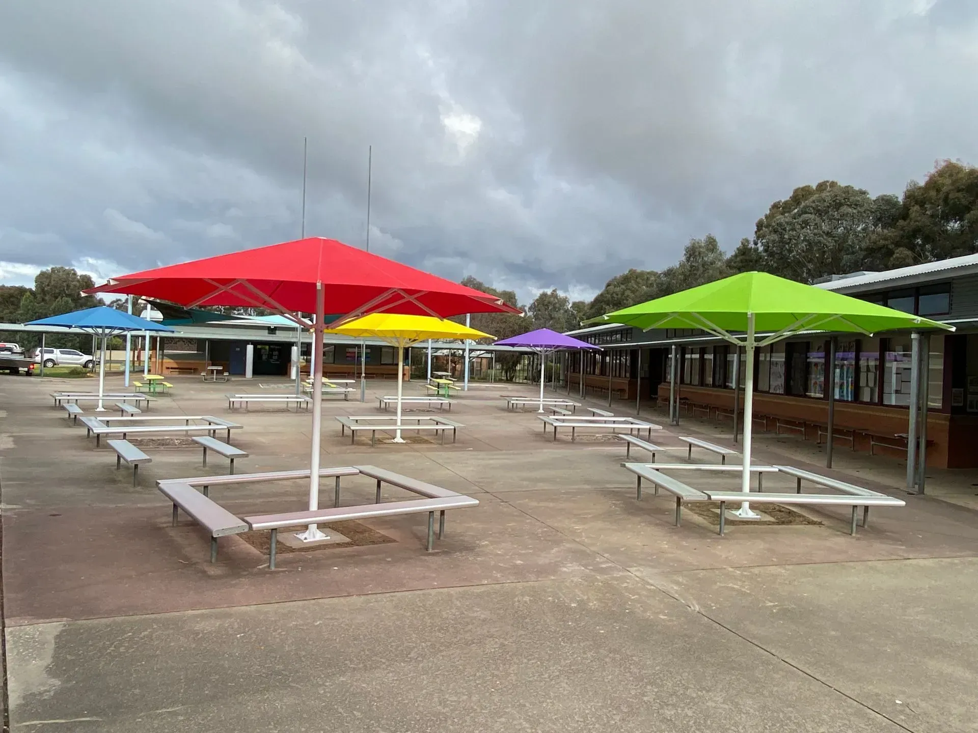 Colourful Umbrellas Over Outdoor Seating Area — The Gazebo and Shade Centre in Jindera, NSW