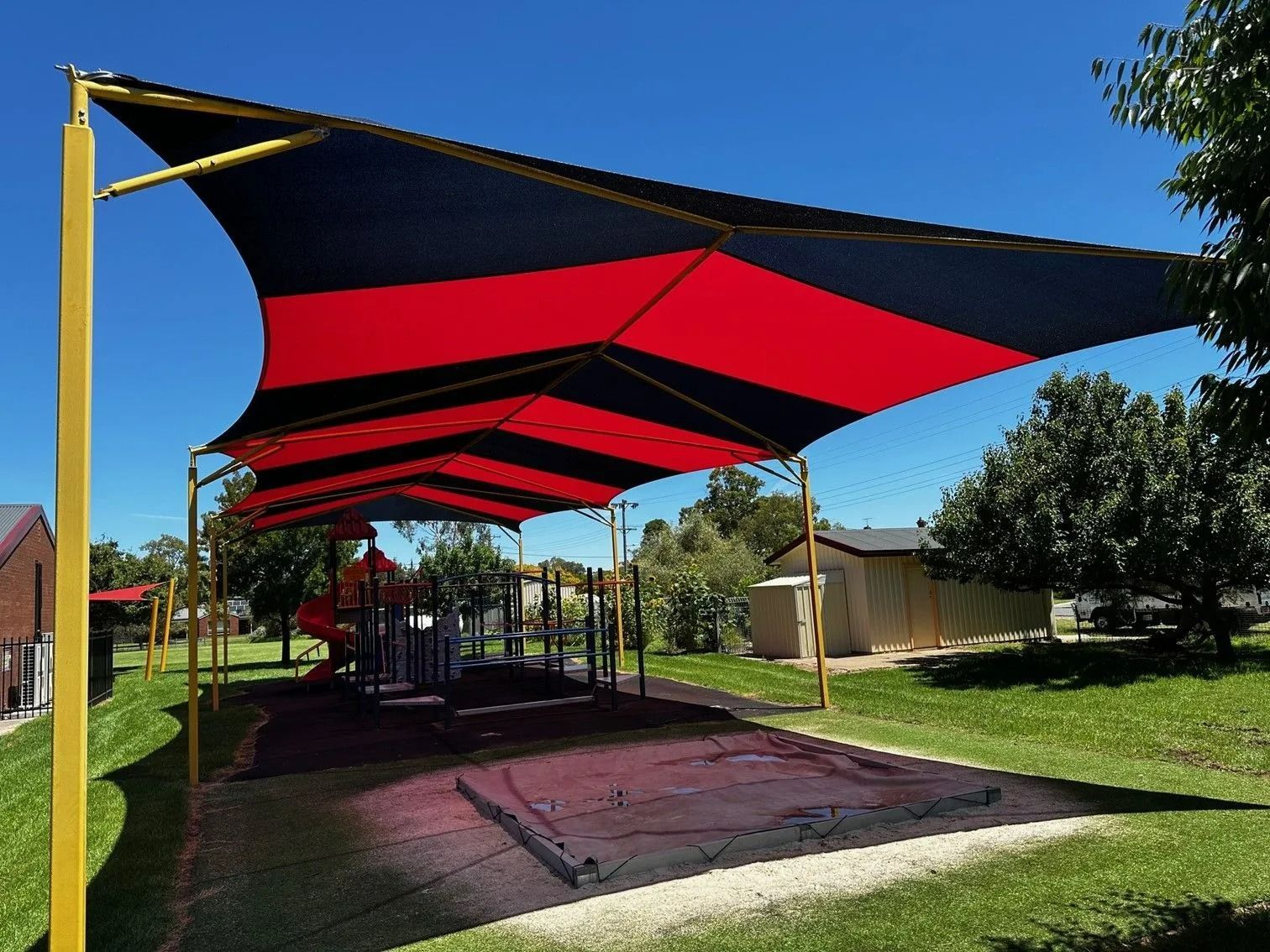 Playground With Red and Black Shade Sails — The Gazebo and Shade Centre in Jindera, NSW