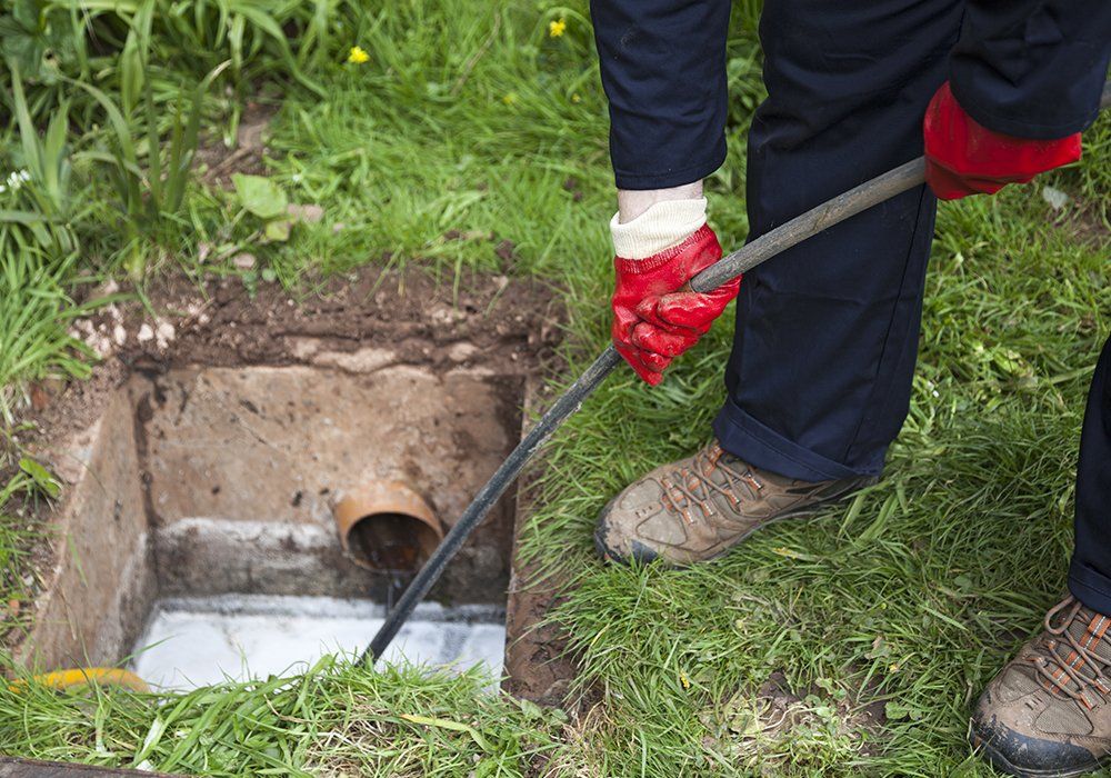 Drain Being Cleared by Worker — El Paso, TX — Plumbers Drain Cleaning Drain Being Cleared by Worker — El Paso, TX — Plumbers Drain Cleaning