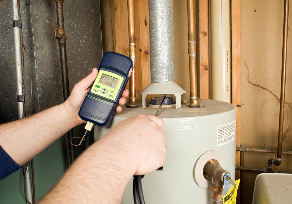 Repairman Checks Carbon Monoxide Level — El Paso, TX — Plumbers Drain Cleaning Repairman Checks Carbon Monoxide Level — El Paso, TX — Plumbers Drain Cleaning