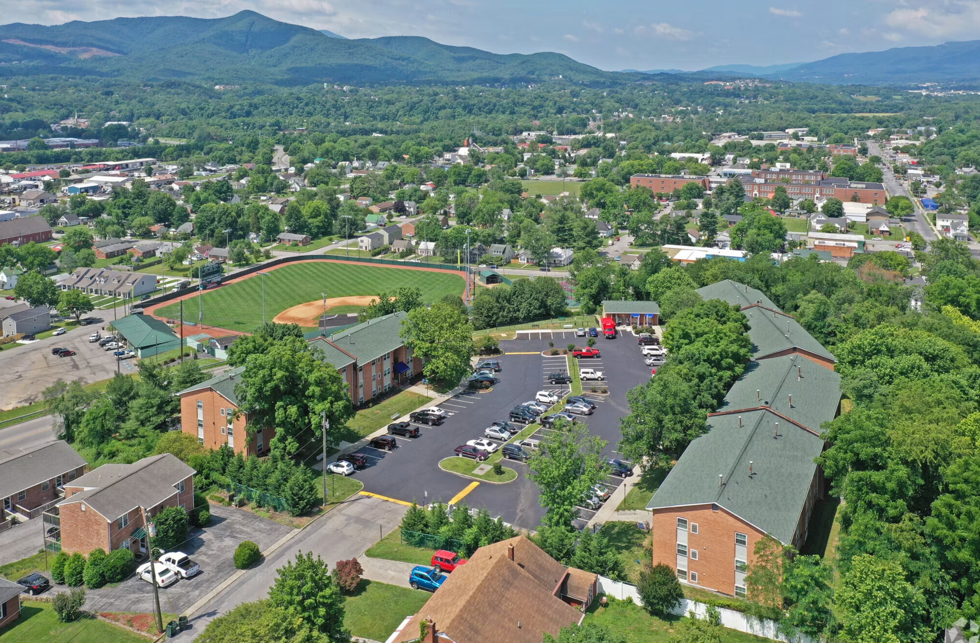 An aerial view of a small town with mountains in the background.