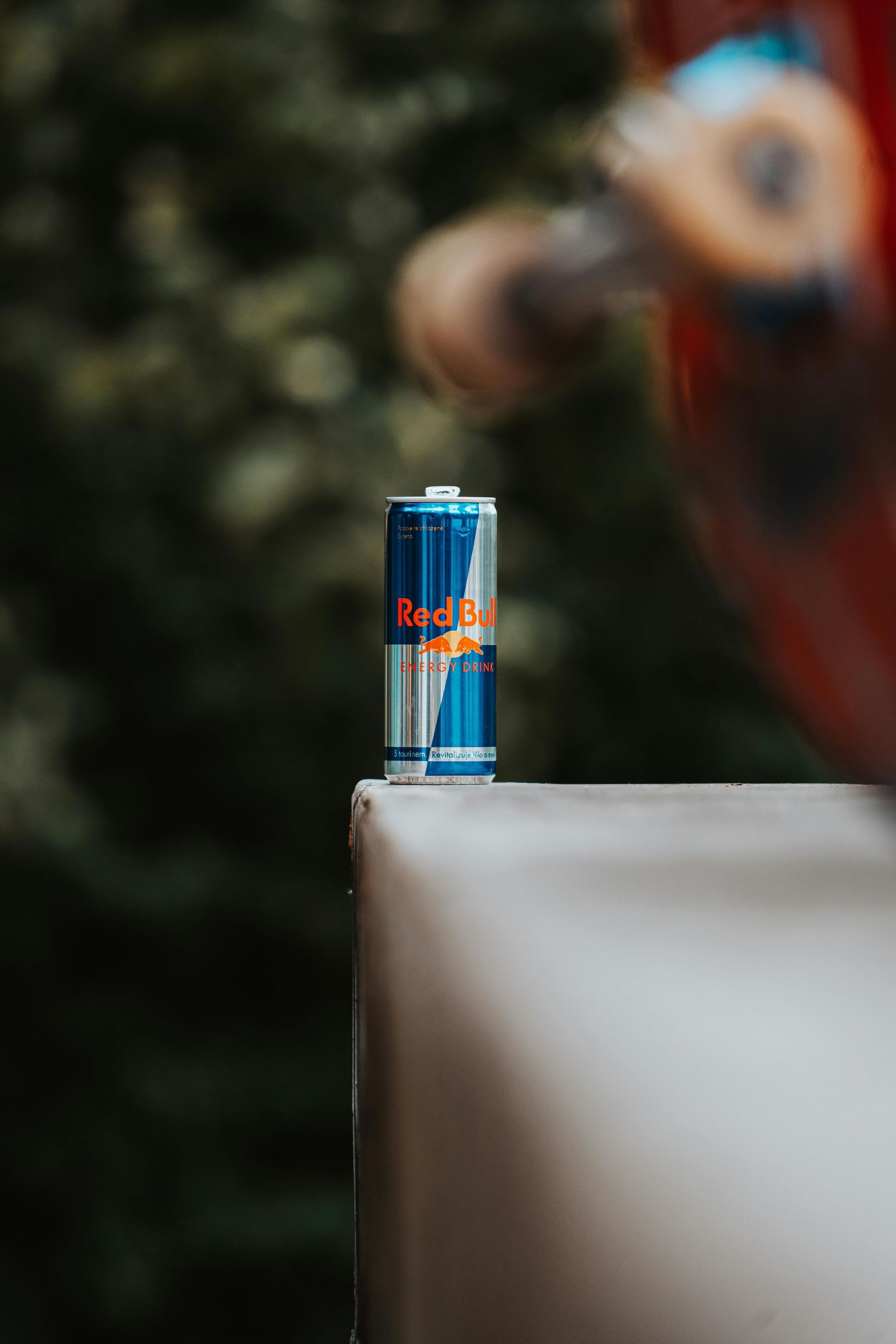 Red Bull can on a white ledge with a blurred background