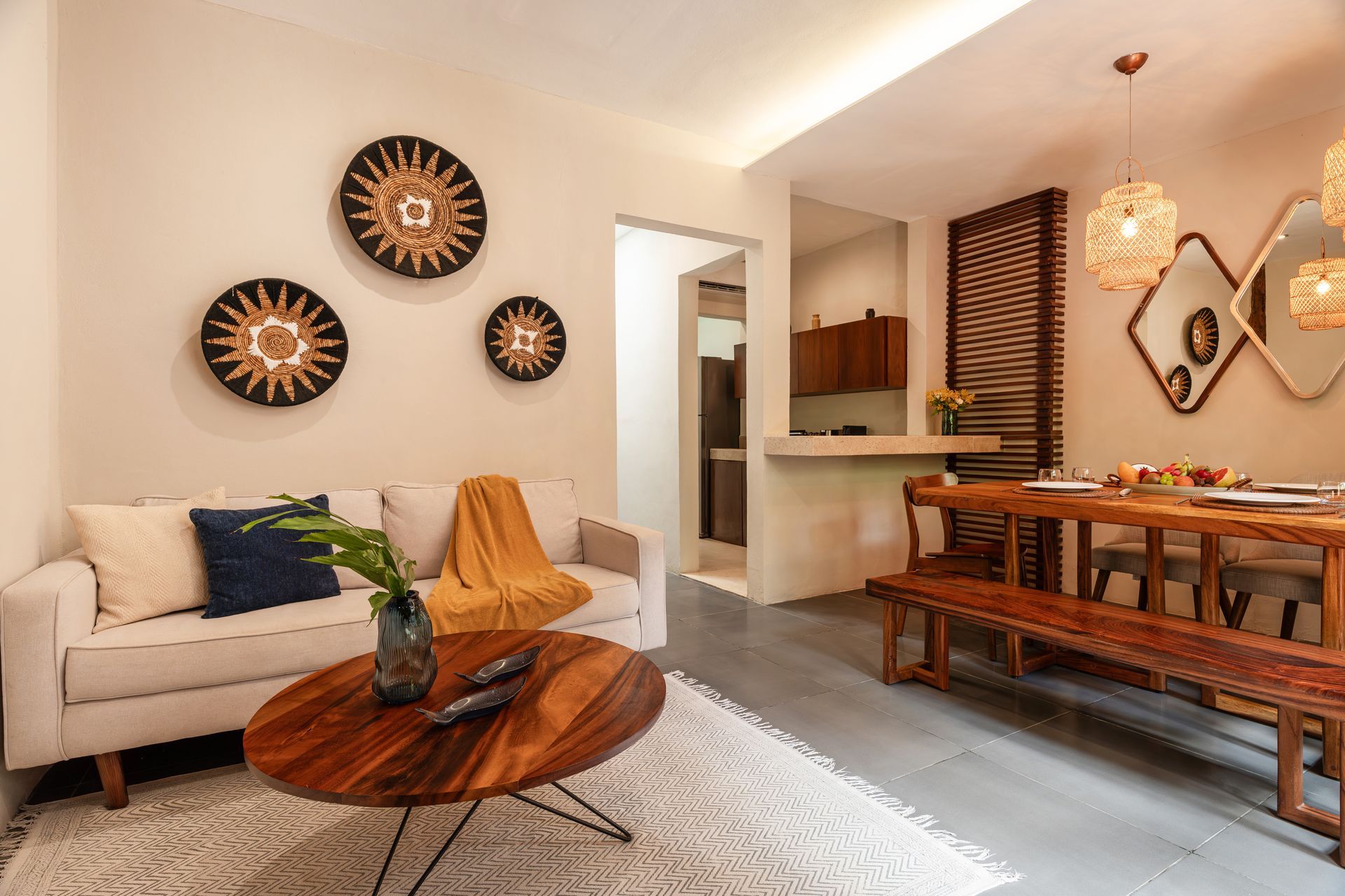 Living room with sofa, wooden table, and woven wall art.