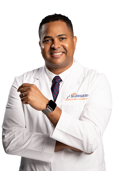 A man in a white lab coat and tie is smiling with his arms crossed.