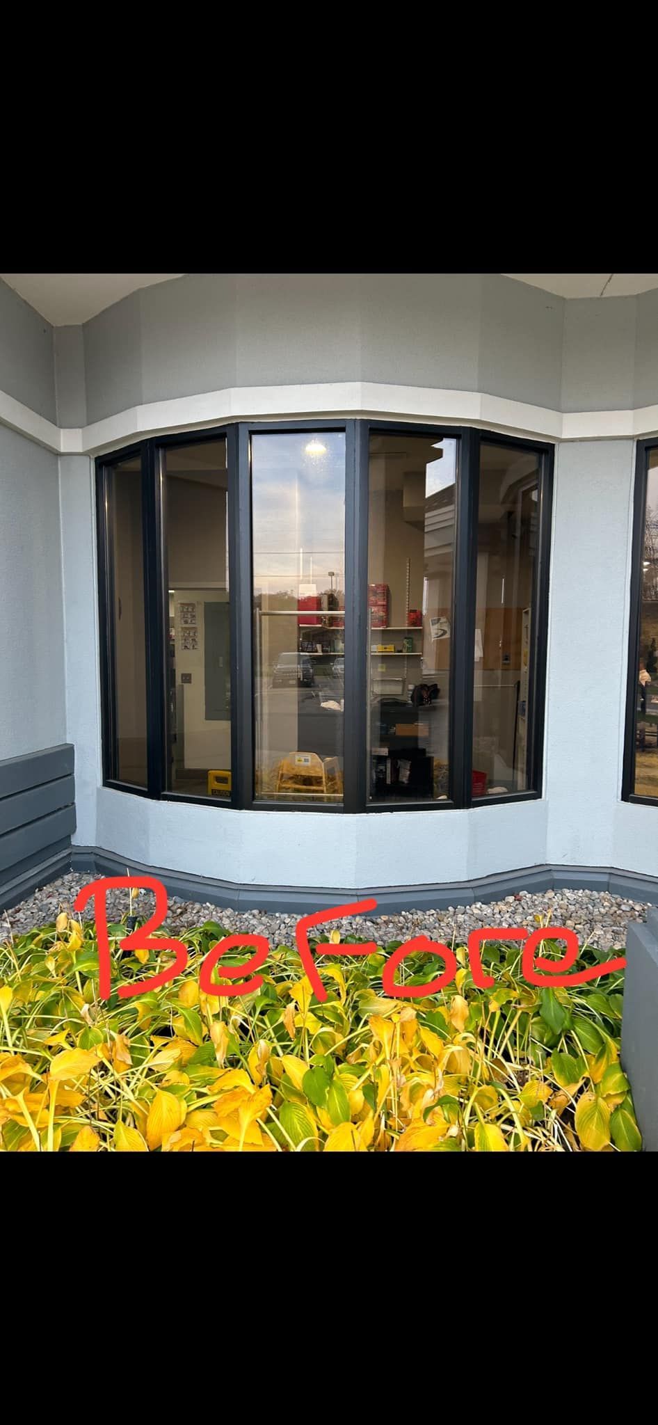 Front of a house with a bay window, white trim, and red “Before” text over yellow flowers.
