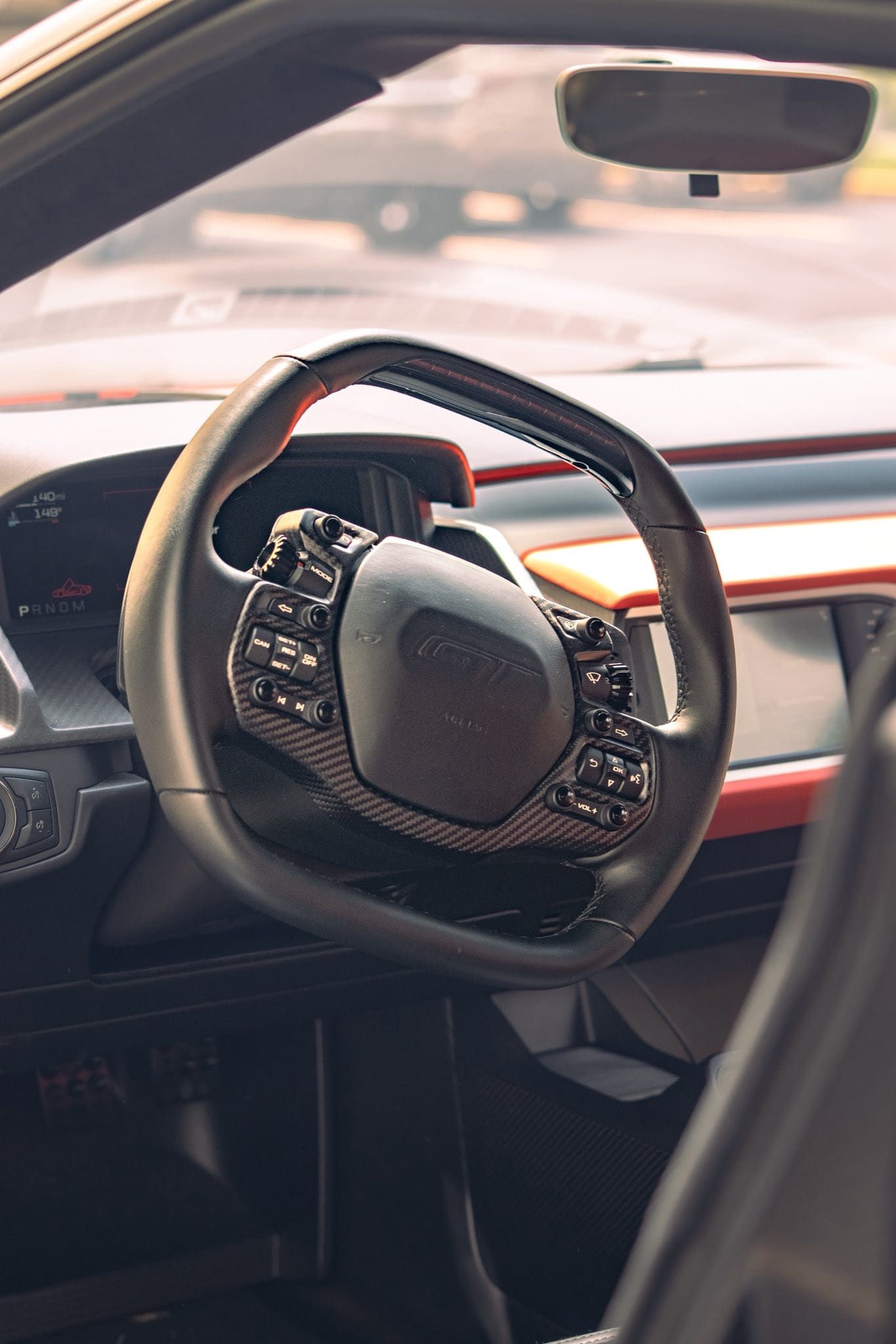 Interior of a car showing the steering wheel and dashboard from the driver’s seat