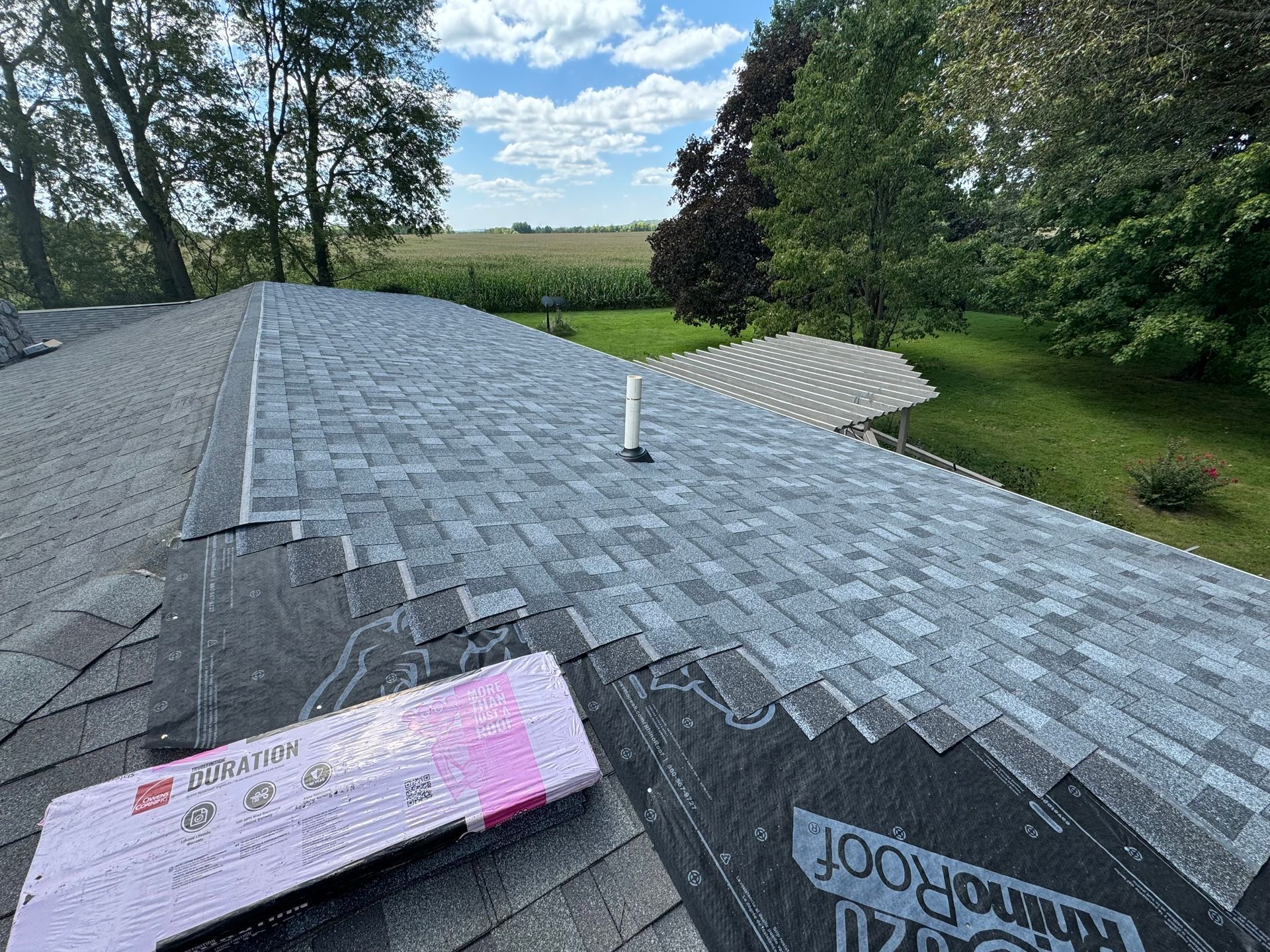 A roof with a lot of shingles on it is being repaired.