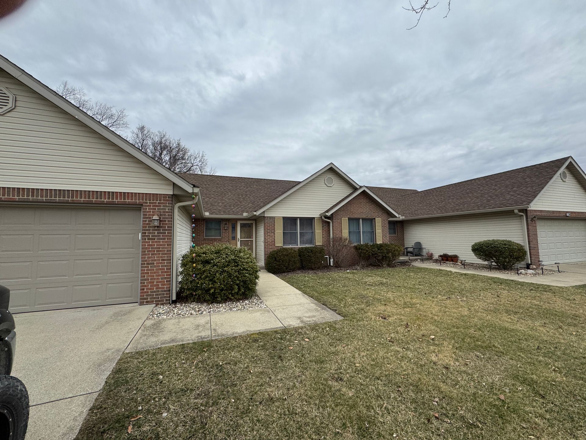 A house with two garages and a brick facade is for sale.
