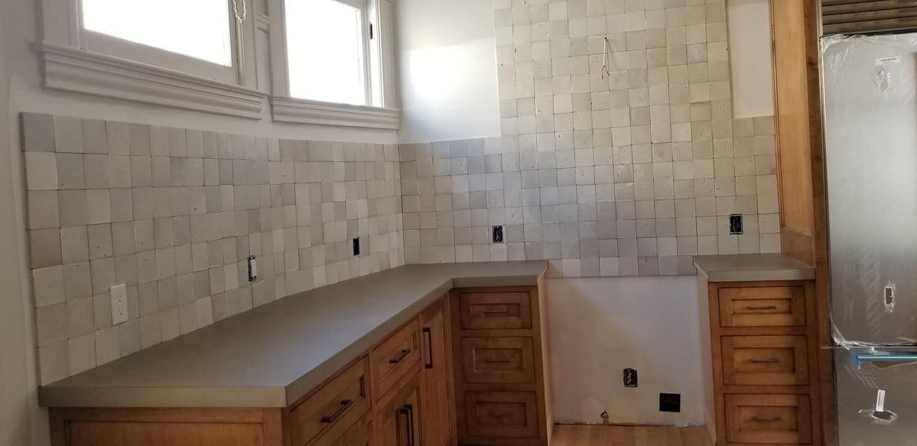 A kitchen with wooden cabinets and a sink.