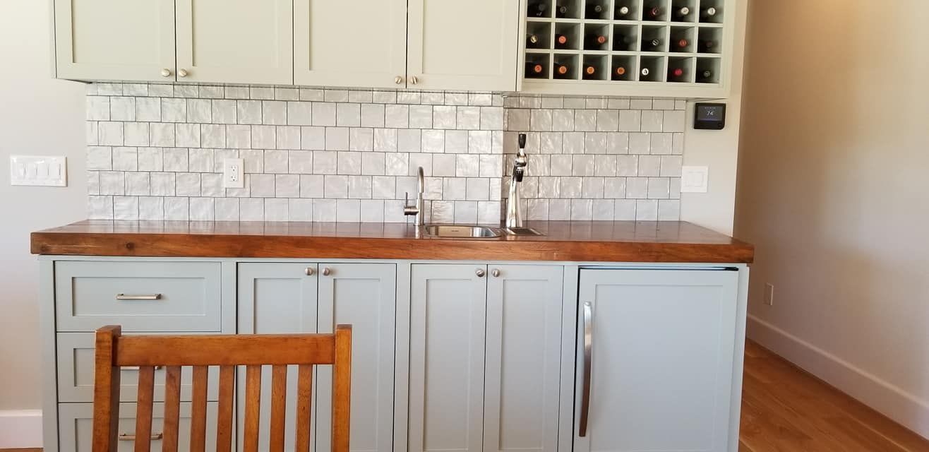 A kitchen with blue cabinets and a wooden counter top