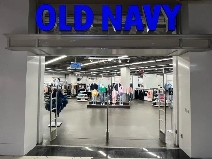 Old Navy store entrance with blue sign and clothing displays inside