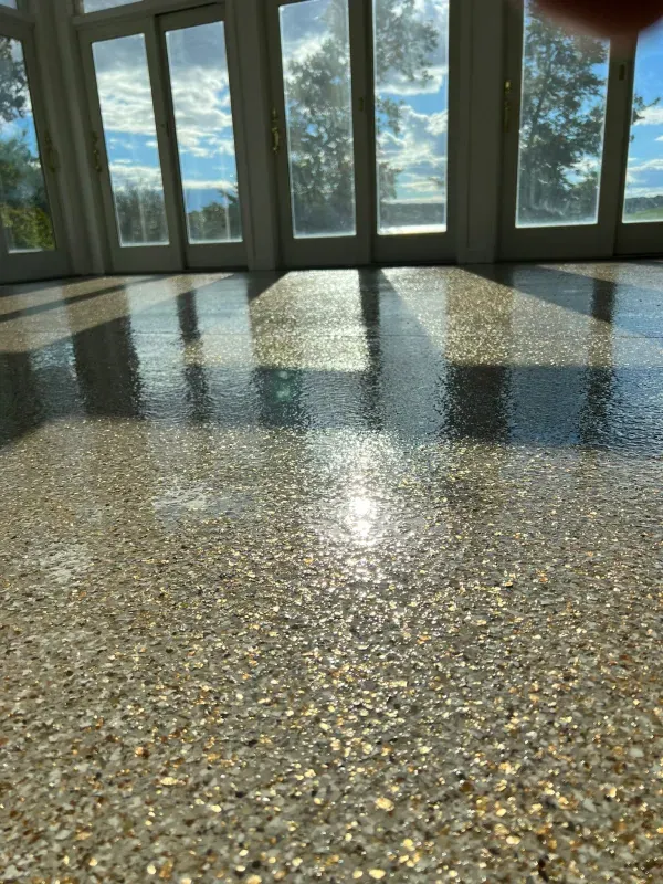 Sunlit terrazzo floor reflecting windows and clouds in a bright room