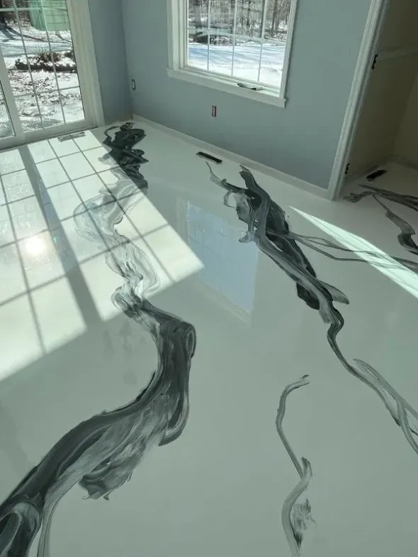 Sunlit room with a glossy floor and dark streaks, near windows and an open doorway
