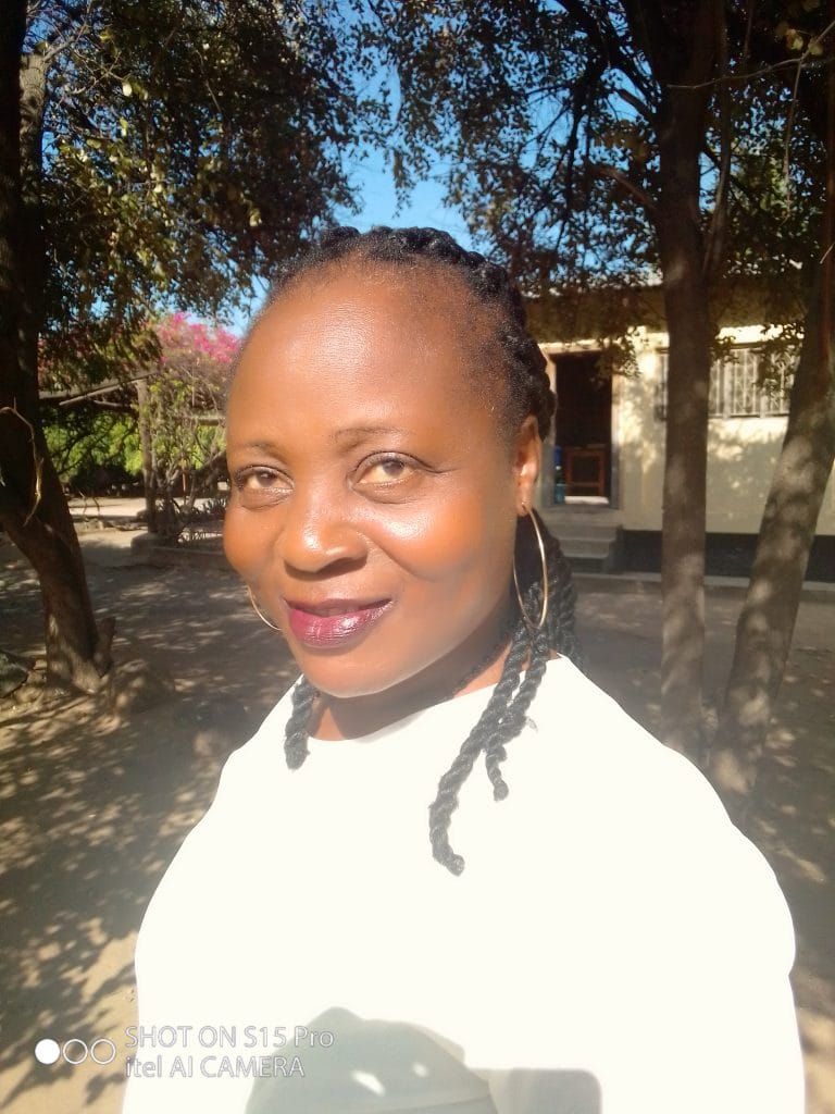 florence Kondwani a malawi children's village social worker pictured outside