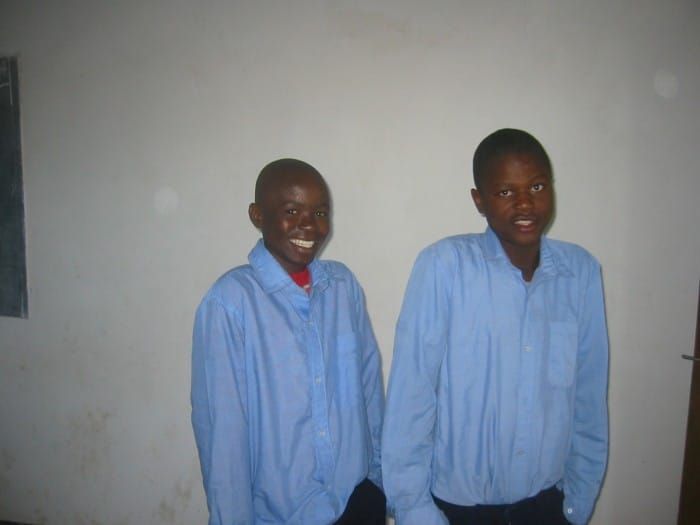 Picture of young Ellaton Siyabu and his friend Morris Katunga in blue shirts in 2007 at Gracious.