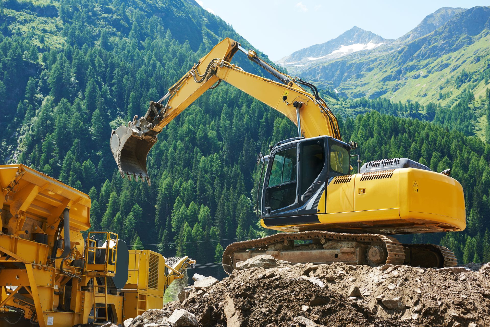 excavator loader machine loading dumper truck at construction site