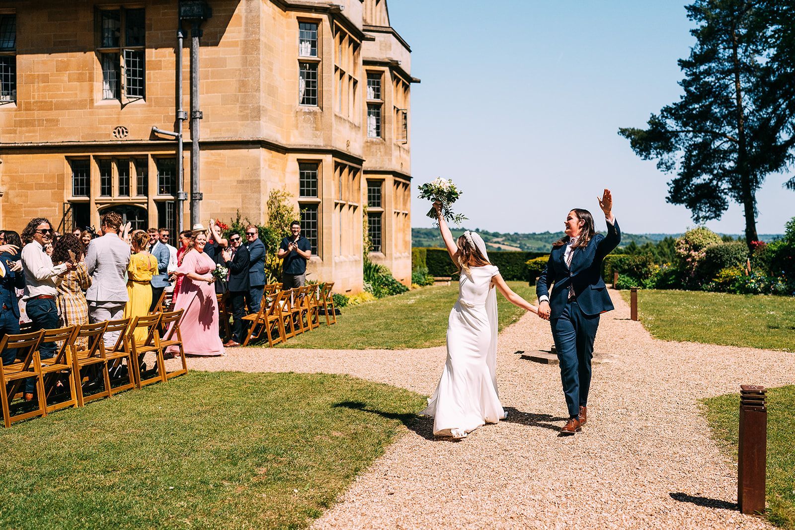 A bride and groom are walking down the aisle at their wedding.