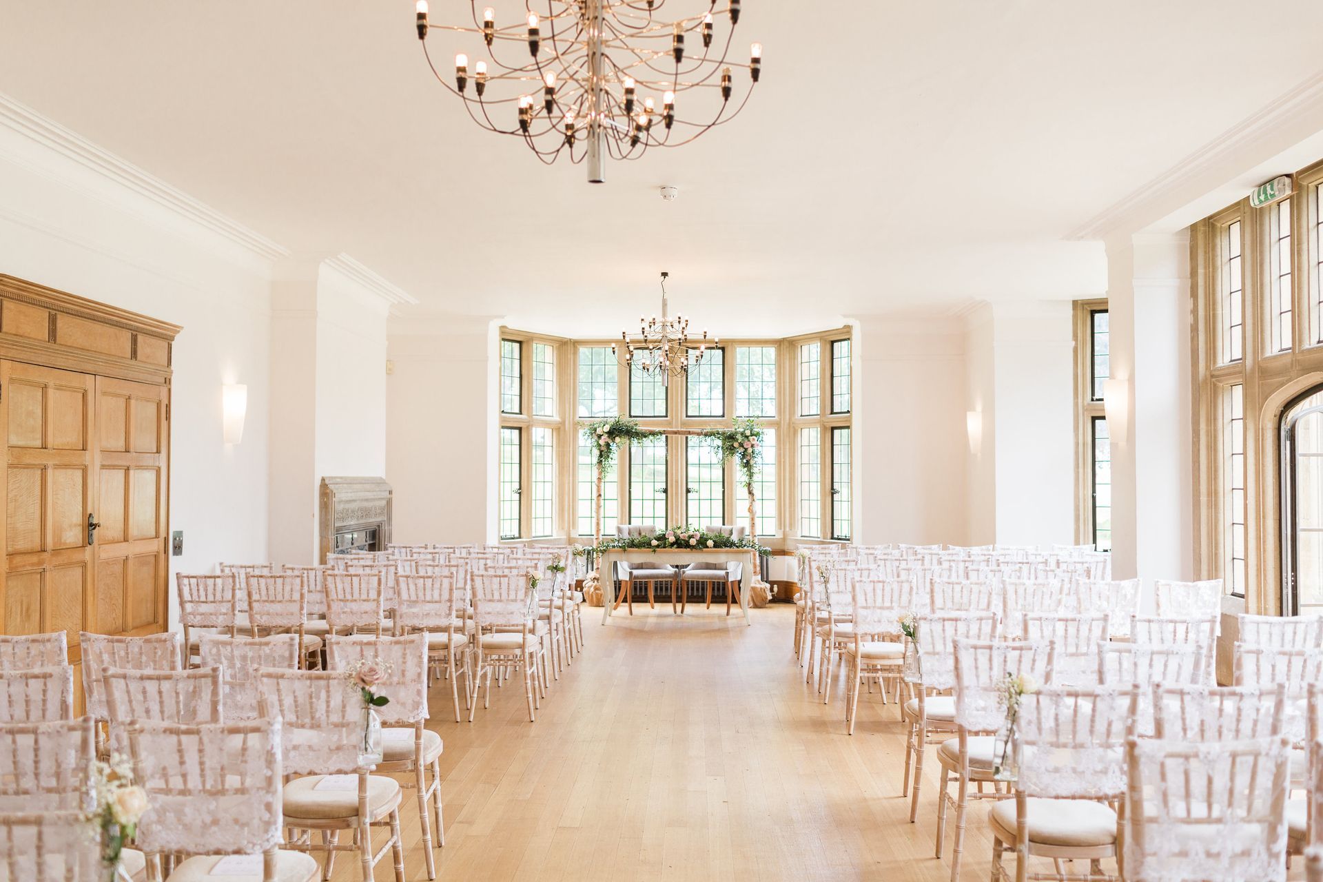 A large room with rows of chairs and a chandelier.