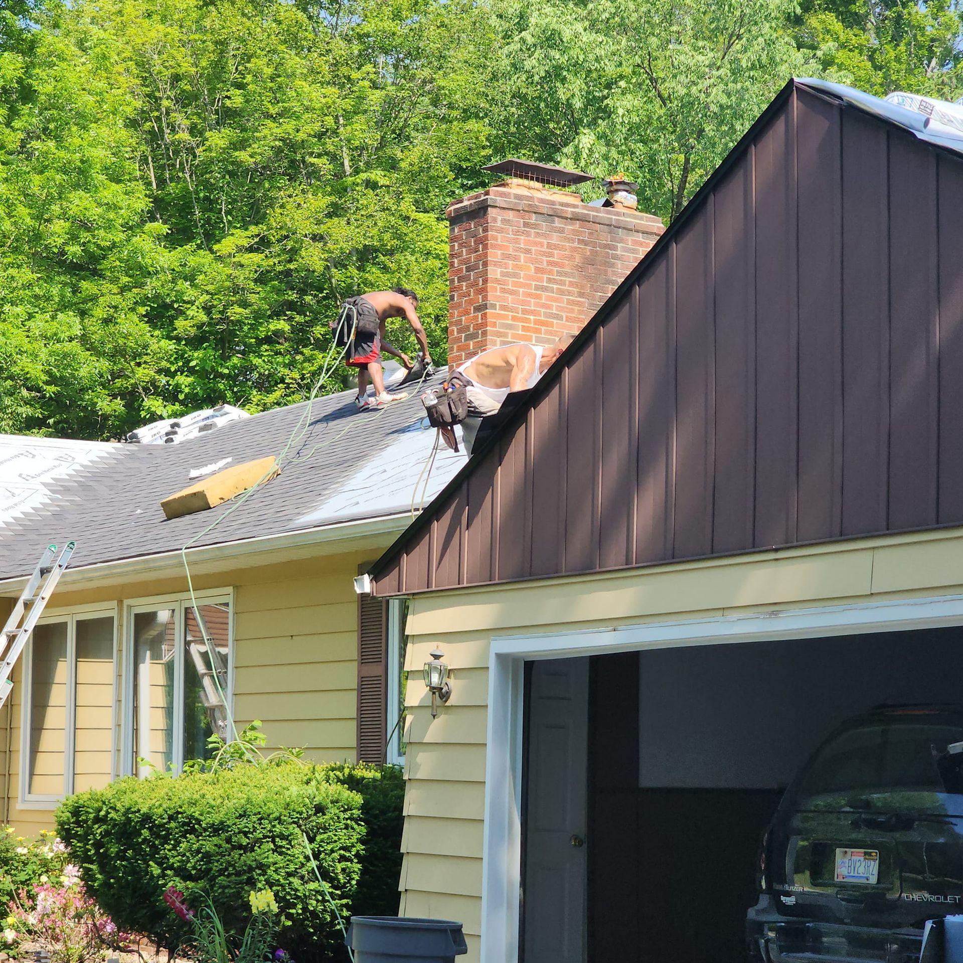 A man is working on the roof of a house