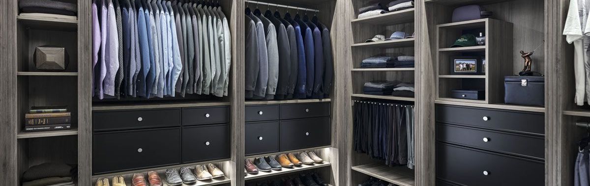 A walk in closet filled with lots of clothes and shoes.