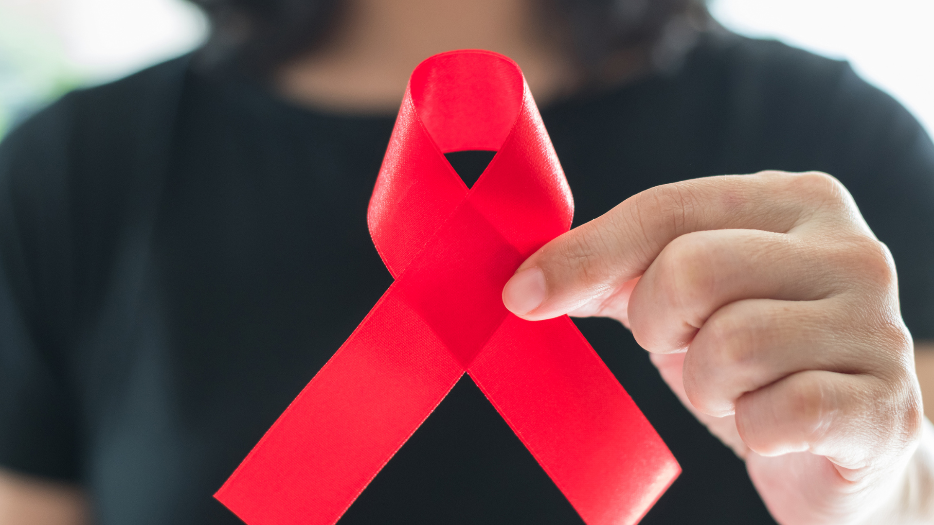 pink ribbon held
