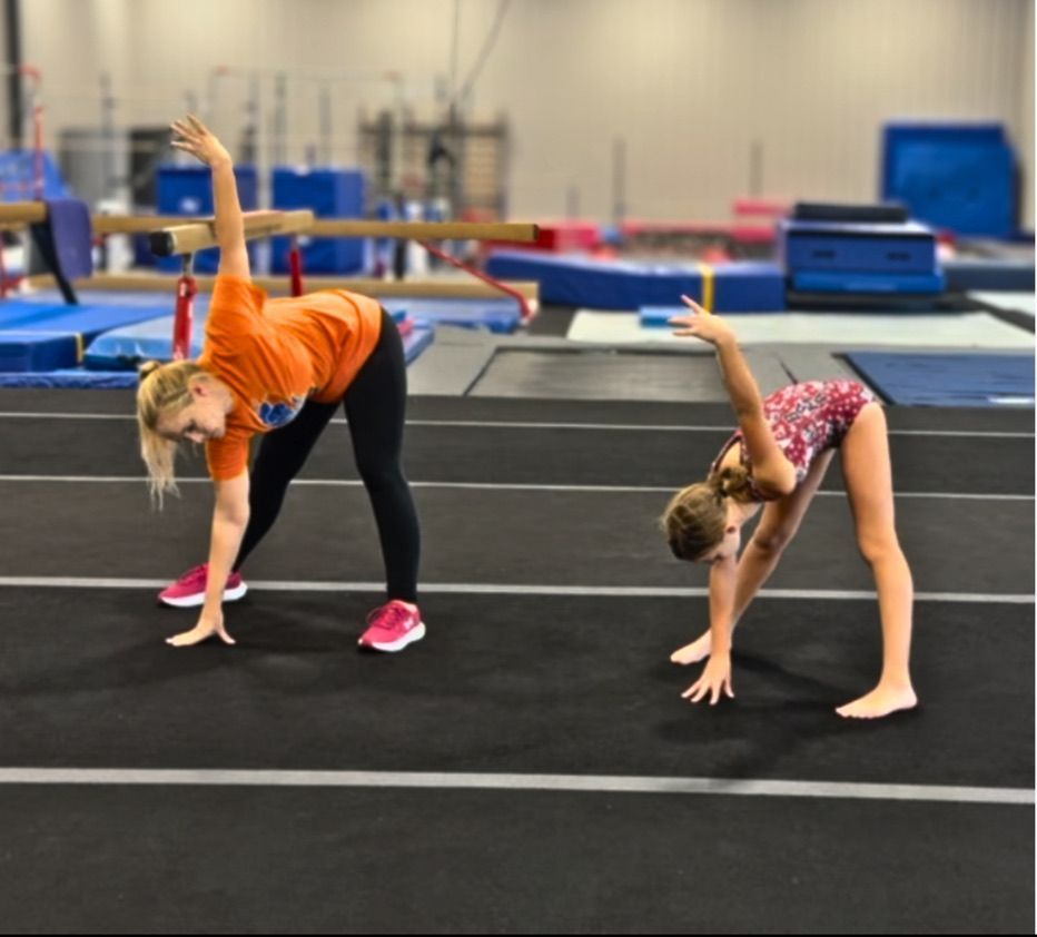 Coach teaching gymnast floor routine choreography