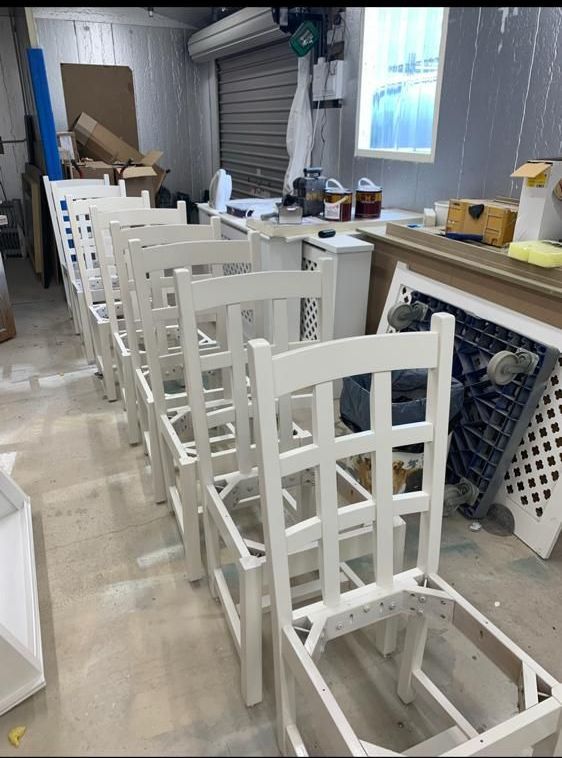a row of white chairs are sitting in a room .
