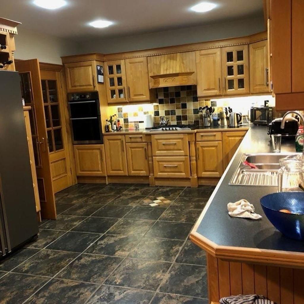 a kitchen with wooden cabinets and stainless steel appliances