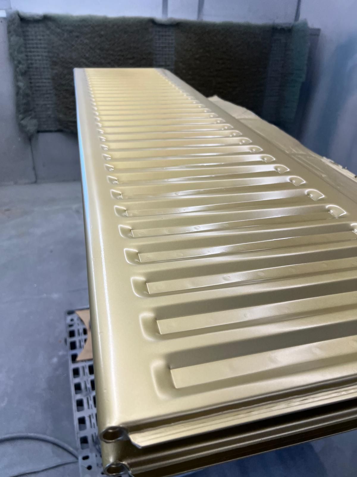 A gold radiator is sitting on a shelf in a room.