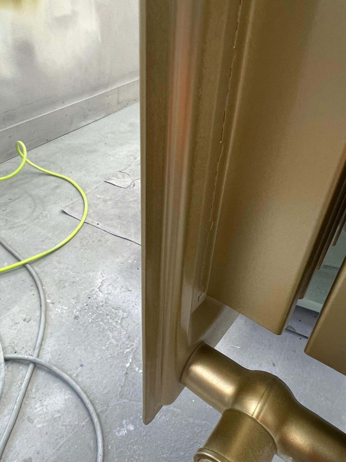 A close up of a door with a yellow cord hanging from it.
